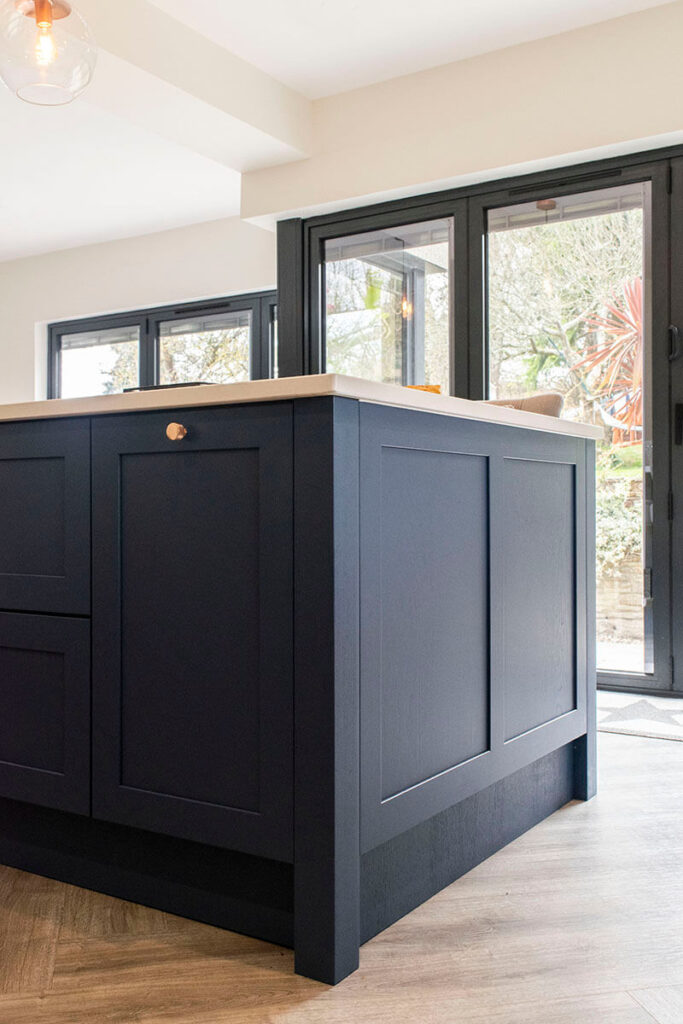 The kitchen island is finished in Parisian blue