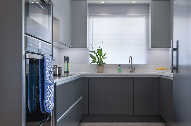 Small kitchen featuring grey handleless doors