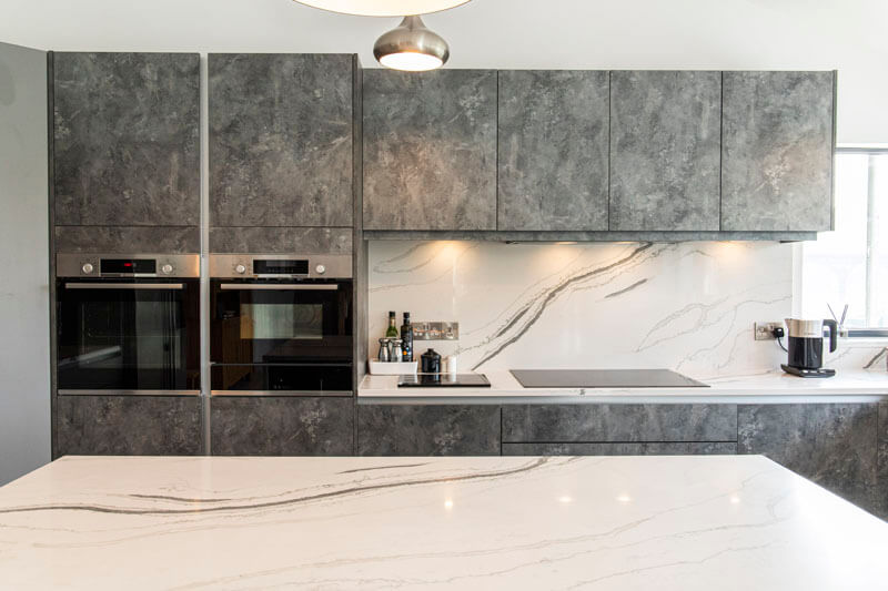 Our Cary handleless kitchen door which is finished in both Dust Grey and a unique Anthracite metal rock