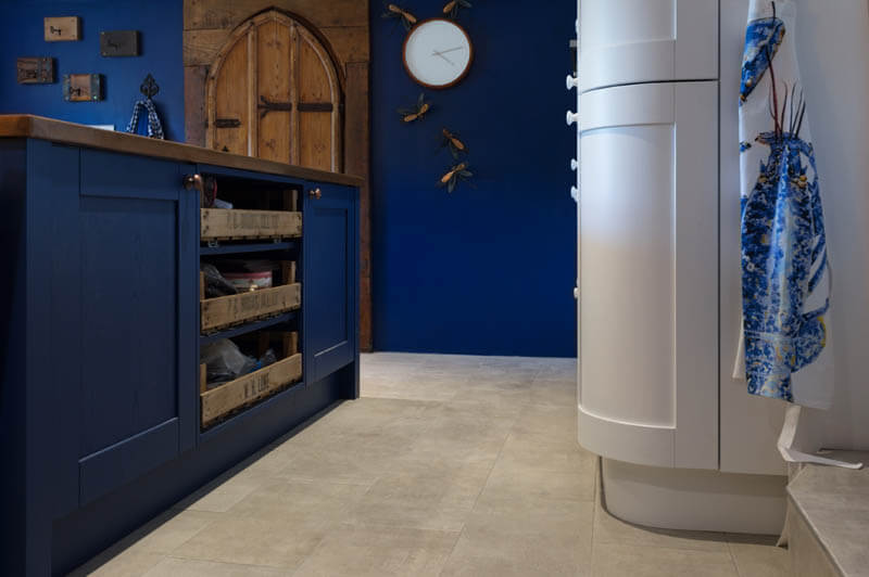 Stone flooring contrasts well with a navy blue colour scheme 