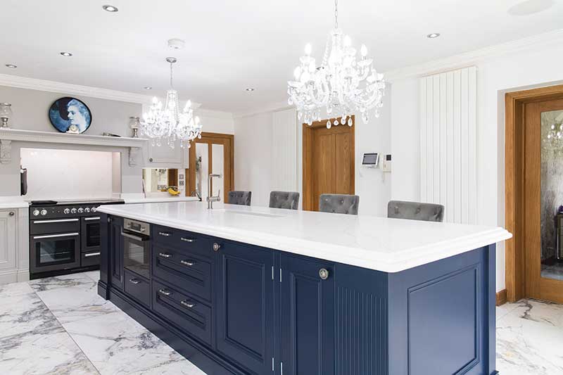 This opulent bespoke kitchen from Williams & sons is finishes in a classic white and navy blue colour scheme